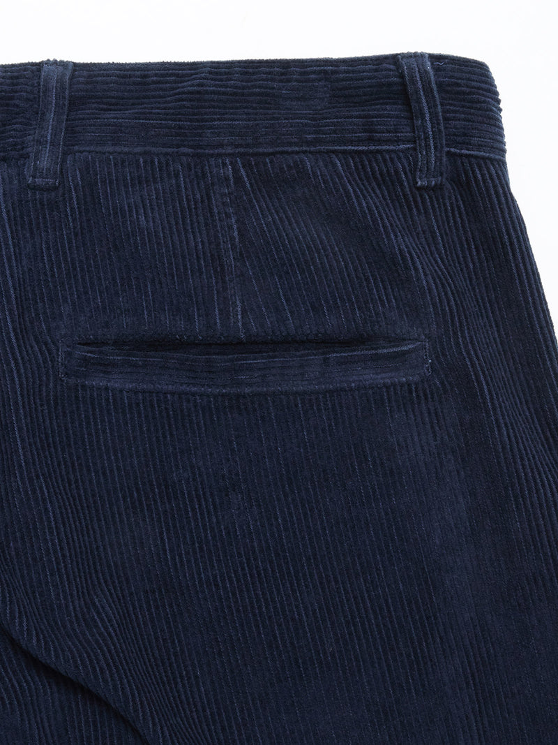 Close-up of the back pocket area of Blue de Gênes Etsu Cord Chino - Navy, featuring vertical corduroy ridges and a single welt pocket in a relaxed fit.