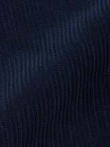 Close-up of Blue de Gênes Etsu Cord Chino - Navy fabric, featuring soft raised vertical ridges and subtle shadows that highlight the textured, wavy pattern of this relaxed fit corduroy chino textile.