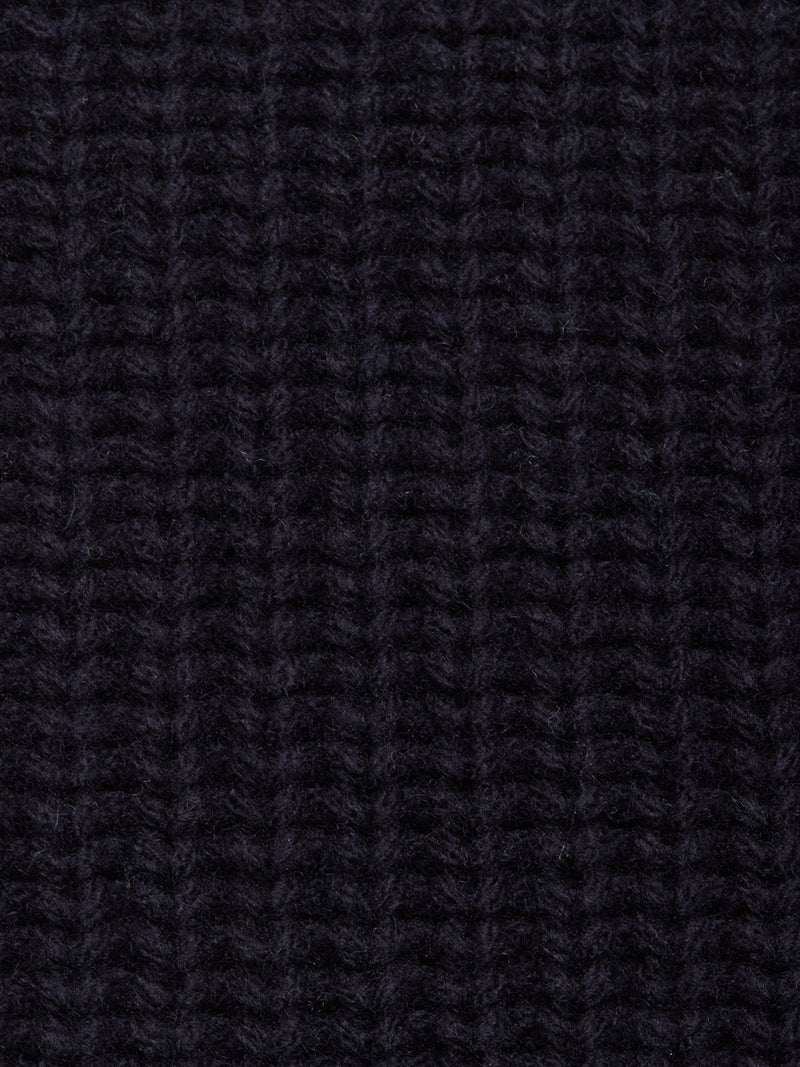 Close-up of the Yomaha Halfzip Knit in Navy by Blue de Gênes, highlighting its dark ribbed knit with a vertical pattern, textured surface, and soft chunky fibers.