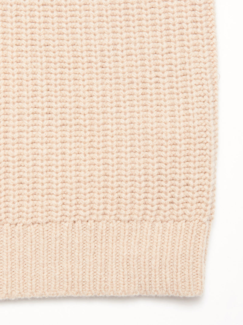 Close-up of the Yomaha Halfzip Knit - Fungi by Blue de Gênes, featuring a beige wool blend with a ribbed hem and waffle-textured knit—ideal for a cosy, chunky sweater.