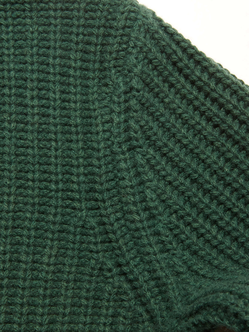 Close-up of the Yomaha Halfzip Knit - Scarab by Blue de Gênes, featuring dark green chunky ribbed knit with detailed stitching. The soft, thick wool blend suggests a cozy sweater ideal for cold weather.