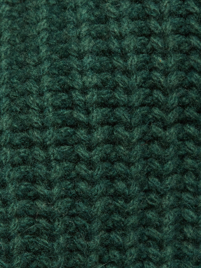 Close-up of the Yomaha Halfzip Knit - Scarab by Blue de Gênes, featuring dark green ribbed chunky knit with textured woolly fibers and a vertical pattern—ideal for a cozy jumper.