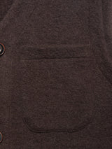 Close-up of the Blue de Gênes Koi Wool Gilet in Chocolate, highlighting its brown textured fabric, patch pocket, and two dark buttons on the left edge.