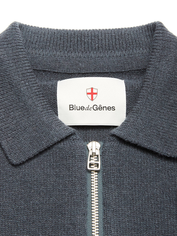 Close-up of the Nuvali Polo Cardigan in Dark Slate—a textured men's zip-up cardigan with collar. The inside label displays Blue de Gênes and a red and white shield logo.