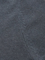Close-up of the dark blue knitted fabric from the Blue de Gênes Nuvali Polo Cardigan in Dark Slate, highlighting visible stitching and a diagonal seam detail.