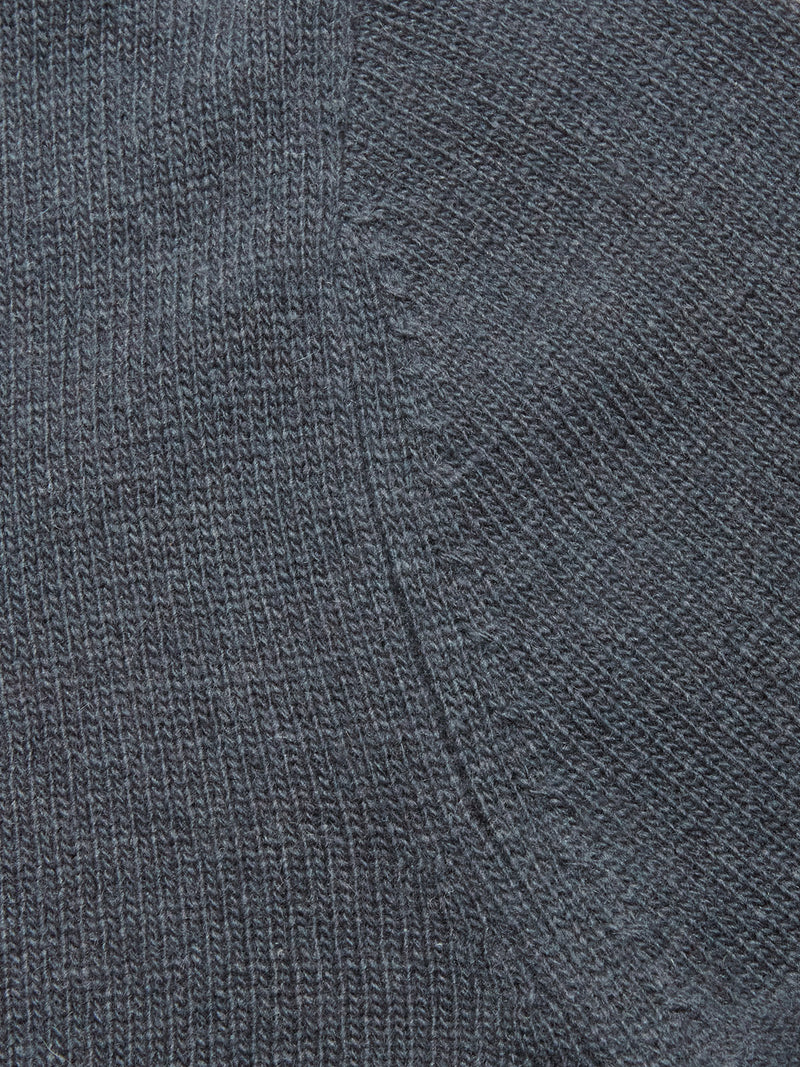 Close-up of the dark blue knitted fabric from the Blue de Gênes Nuvali Polo Cardigan in Dark Slate, highlighting visible stitching and a diagonal seam detail.