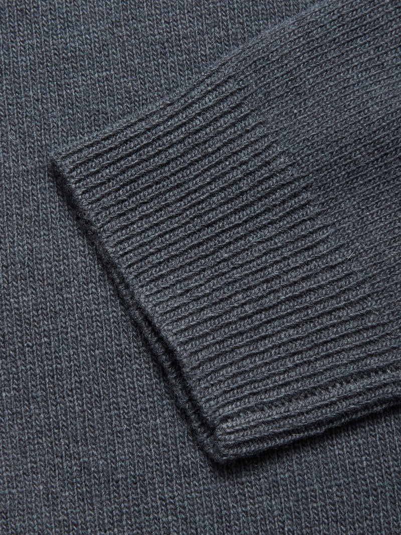 Close-up of the sleeve cuff on the Blue de Gênes Nuvali Polo Cardigan - Dark Slate, highlighting its ribbed texture and fine, even stitching for a modern men's look.