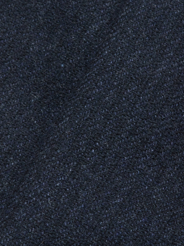 Close-up of the Blue de Gênes Kibishi Solid Pant in Dark Navy, featuring Italian wool-blend fabric with a textured, slightly fuzzy surface and a subtle diagonal crease—perfect for tailored pants.