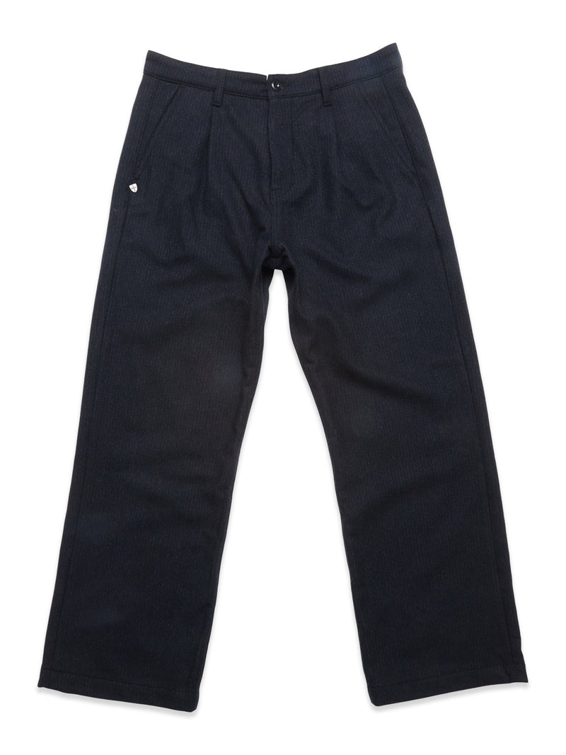 The Blue de Gênes Kibishi Solid Pant in dark navy is a straight-leg style crafted from an Italian wool blend with pleats, belt loops, and a button closure, shown laid flat on a white background.