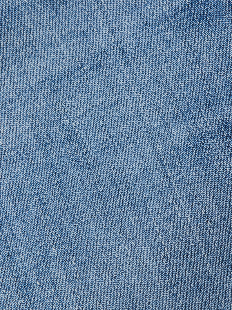 Close-up view of the light blue comfort stretch denim fabric of Blue de Gênes Vinci Girisha Used Jeans, highlighting the diagonal weave pattern and texture typical of regular fit jeans.