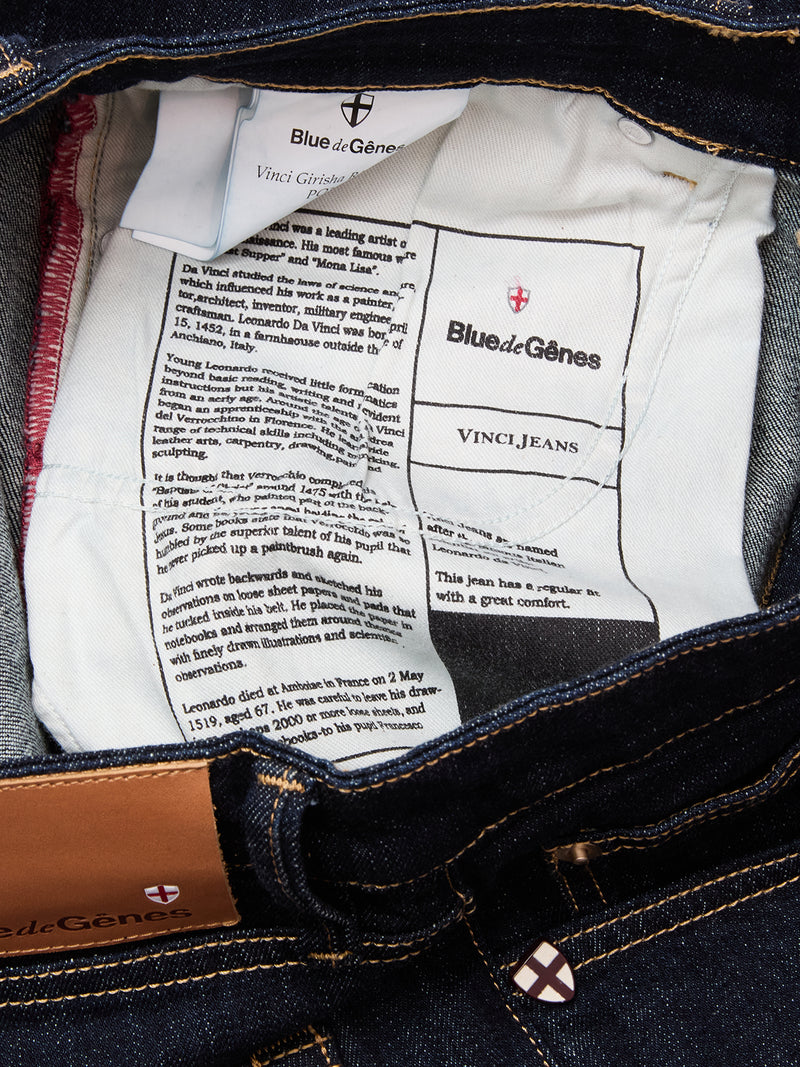 The inside label of Blue de Gênes Vinci Girisha Rinse Jeans - Rinse Wash displays brand and care tags, product info, and stitching on dark blue comfort stretch denim.