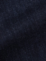 Close-up of Vinci Girisha Rinse Jeans by Blue de Gênes, highlighting the dark blue stretch denim’s textured weave and subtle white specks—a signature of quality five-pocket jeans.