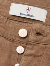 Close-up of Blue de Gênes Vinci Iro Pant – Chocolate, crafted in comfort stretch twill with metal buttons and a fabric label featuring the red and white shield logo.
