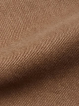 Close-up of brown textured fabric with fine diagonal lines and a gently wavy surface, similar to the soft, woven material featured in the Blue de Gênes Vinci Iro Pant - Chocolate.
