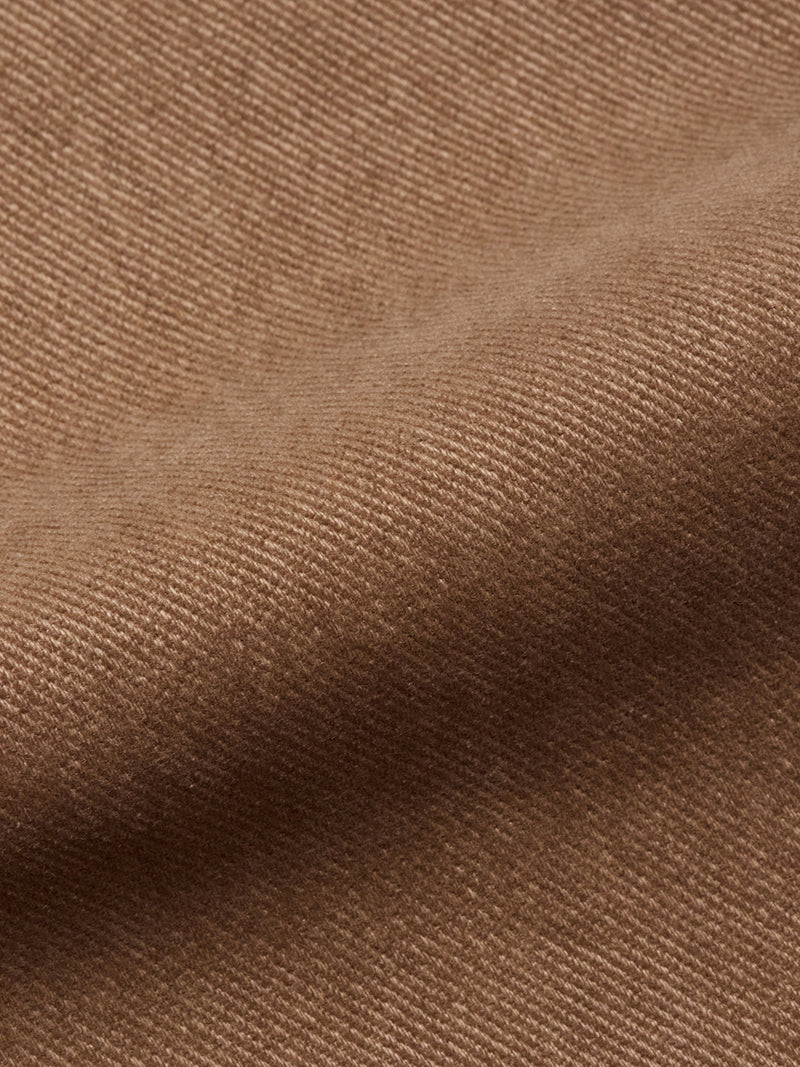 Close-up of brown textured fabric with fine diagonal lines and a gently wavy surface, similar to the soft, woven material featured in the Blue de Gênes Vinci Iro Pant - Chocolate.