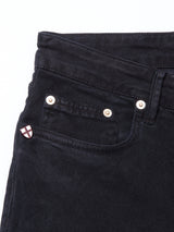 Close-up of the upper part of Blue de Gênes Vinci Iro Pant - Navy, showcasing the waistband, front pocket with rivets, and a small badge featuring a white and red cross on the coin pocket. Made from premium comfort stretch twill for added ease.