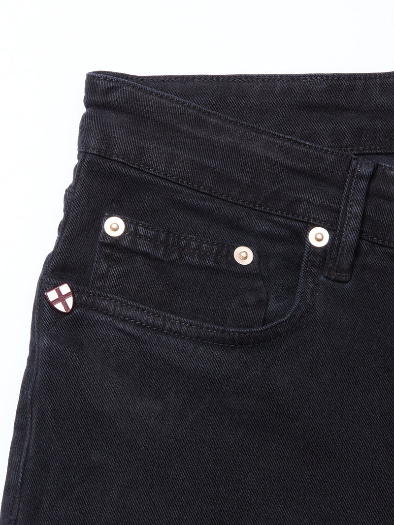 Close-up of the upper part of Blue de Gênes Vinci Iro Pant - Navy, showcasing the waistband, front pocket with rivets, and a small badge featuring a white and red cross on the coin pocket. Made from premium comfort stretch twill for added ease.