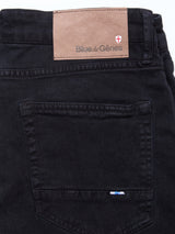 Close-up of the back pocket and waistband of Blue de Gênes Vinci Iro Pant in navy, regular fit with comfort stretch twill, featuring a brown leather brand patch and small stitched flag detail near the pocket.