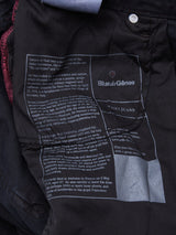 A close-up of the inside label of Blue de Gênes Vinci Iro Pant - Navy, showing printed brand details and text about Leonardo da Vinci on dark comfort stretch twill with visible stitching.