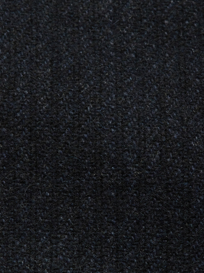 Close-up of the dark, textured fabric of the Blue de Gênes Vincenzo Solid Jacket - Dark Navy, showcasing small visible fibers and a slightly uneven look, ideal for a relaxed fit.