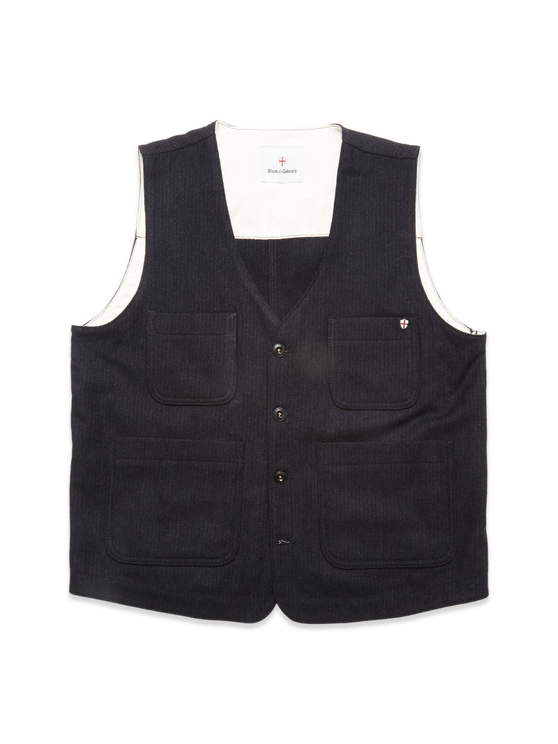 The Blue de Gênes Maurice Solid Gilet - Dark Navy is a sleeveless, V-neck denim vest with button closure, four front pockets, and a white inner lining—ideal for tailored layering. Shown against a white background.