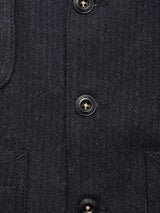 Close-up of the Maurice Solid Gilet - Dark Navy by Blue de Gênes, crafted from a dark blue Italian wool blend with black buttons and visible stitching—an elegant, tailored layering piece.