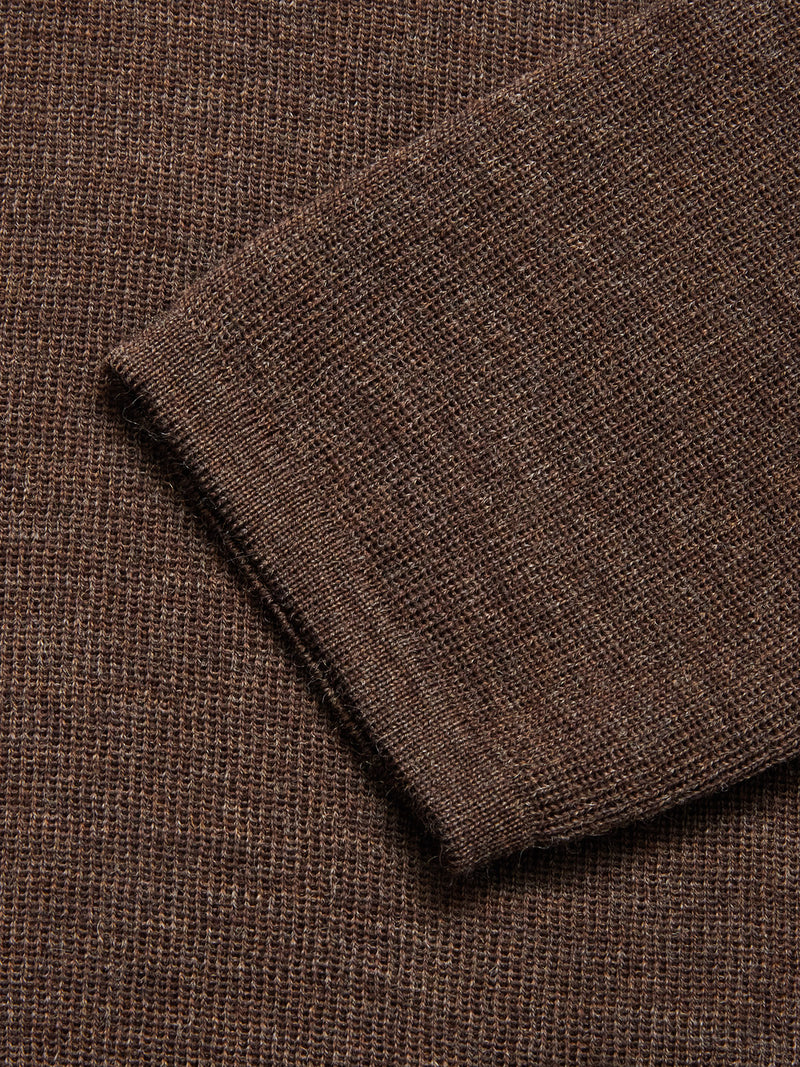 Close-up of the Toyama Knit L/S sweater by Blue de Gênes in brown, showing the sleeve cuff detail and textured knit pattern.