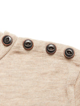 Close-up of the Blue de Gênes Toyama Knit L/S in oat, a beige sweater crafted from Merino wool with four dark brown buttons along the shoulder seam.