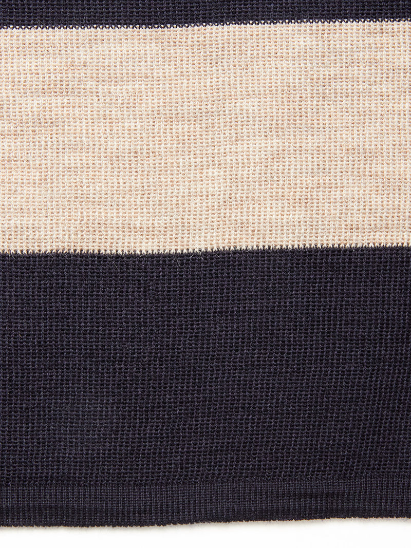 The Blue de Gênes Toyama Stripe Knit L/S - Dark Navy features textured fabric with alternating beige and wide dark navy horizontal stripes for a stylish, detailed look.