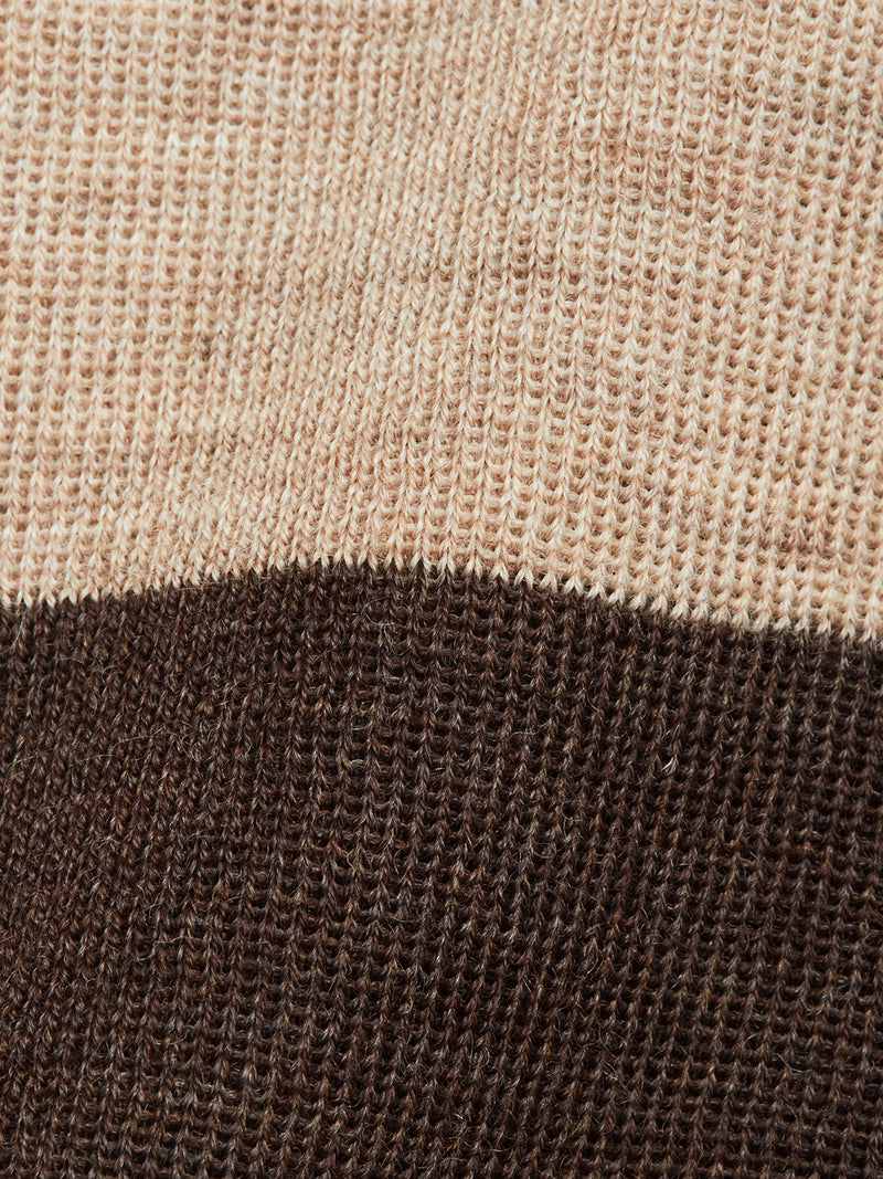 Close-up of the Toyama Stripe Knit L/S - Oat by Blue de Gênes, featuring a crewneck design with beige and dark brown horizontal stripes. The knit texture and threads are clearly visible.