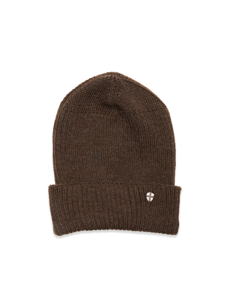 The Boshi Beanie - Brown by Blue de Gênes is a Merino wool rib beanie with a folded brim and small round metallic emblem on the front, knitted in Denmark and shown against a plain white background.