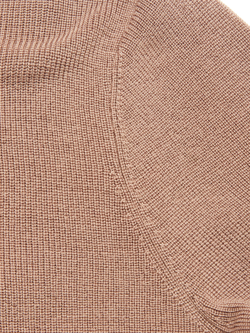 Close-up of the textured Porto Polo Knit - Fungi fabric by Blue de Gênes, highlighting its detailed weave and diagonal seam—showcasing casual elegance in this light brown wool polo shirt.
