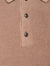 Close-up of the Blue de Gênes Porto Polo Knit - Fungi, a textured light brown wool polo shirt featuring three black buttons and part of the collar, reflecting casual elegance.