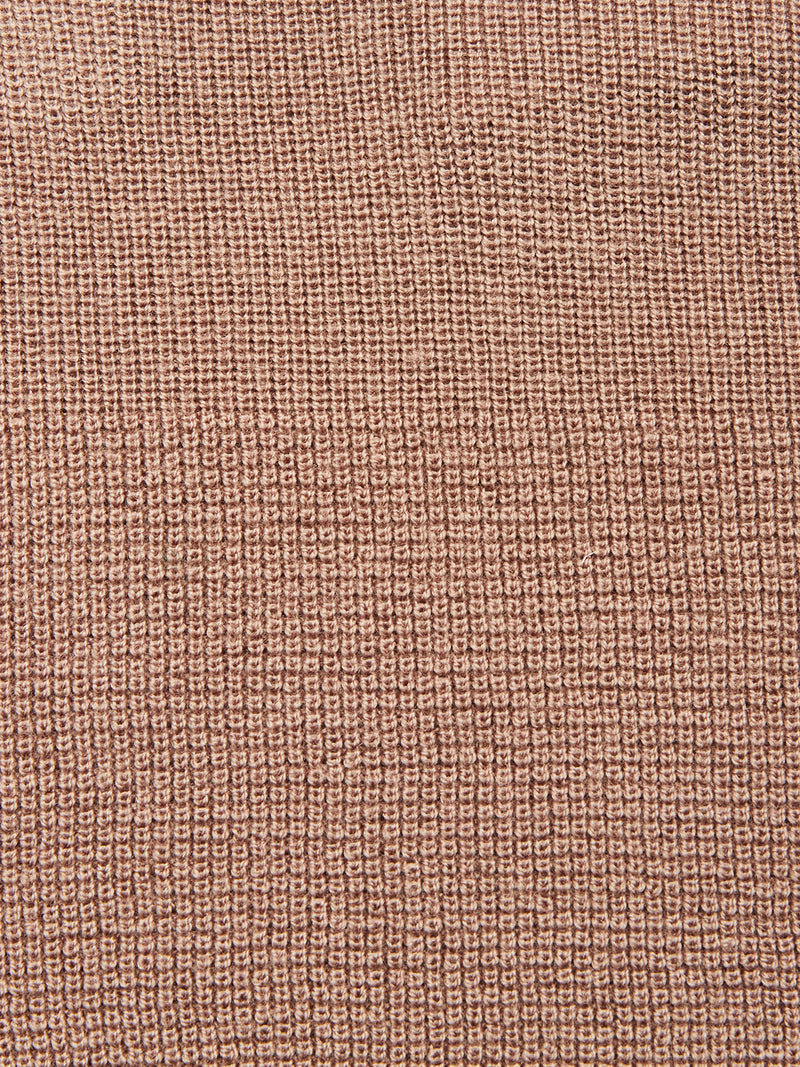 Close-up of the Porto Polo Knit - Fungi by Blue de Gênes: textured warm brown fabric with a grid-like woven pattern and raised squares, capturing the polo's casual elegance.