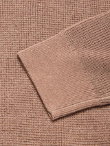 Close-up of the Porto Polo Knit - Fungi fabric by Blue de Gênes, featuring a sweater sleeve over textured light brown knit, highlighting the casual elegance and detailed pattern of this wool polo shirt material.