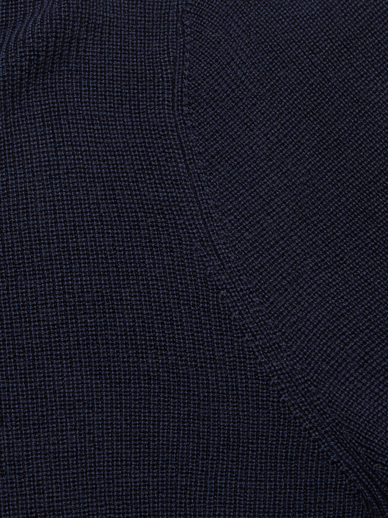Close-up of the Porto Polo Knit - Navy by Blue de Gênes, highlighting its refined wool fabric, visible stitching, and subtle diagonal seam for a touch of casual elegance.