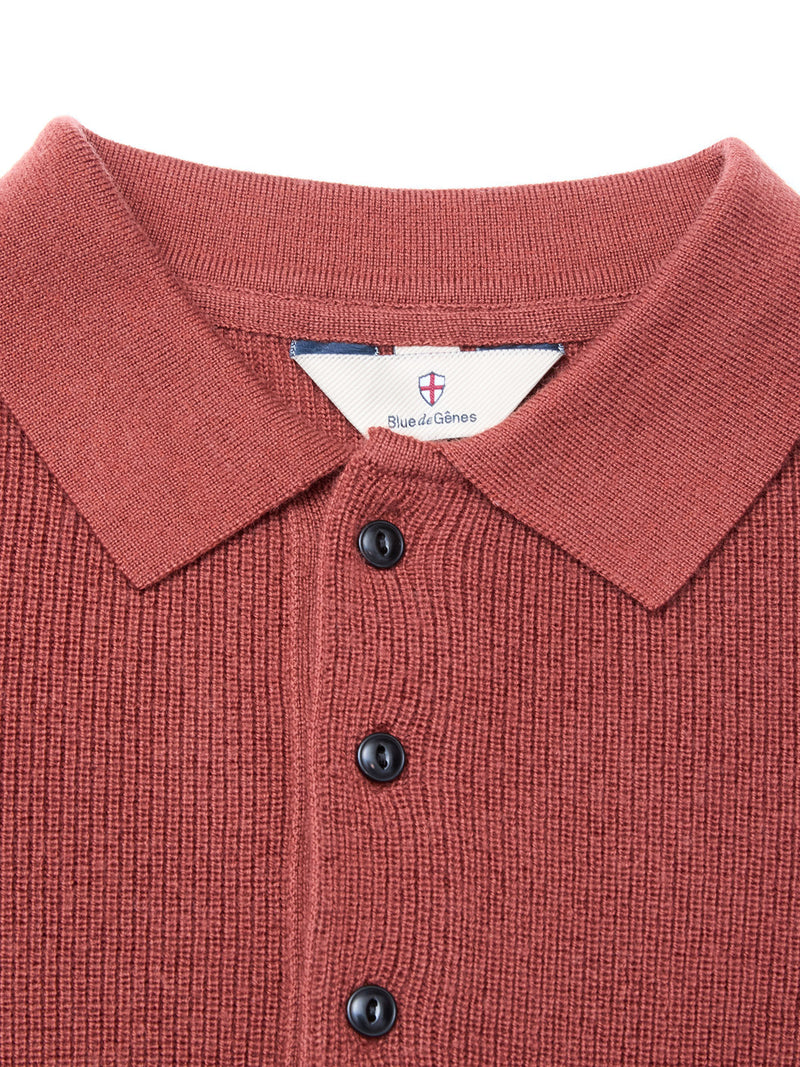 Close-up of the Porto Polo Knit in Henna by Blue de Gênes, featuring a rust hue, collar, three black buttons, and an inner label with brand name and crest—showcasing refined men’s luxury knitwear.