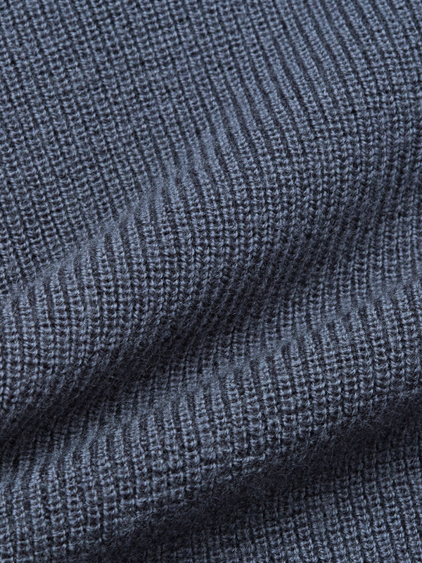 Close-up of the Porto Polo Knit - Dark Slate by Blue de Gênes, showcasing its textured ribbed fabric with vertical lines and soft folds that emphasize the luxury knitwear quality.