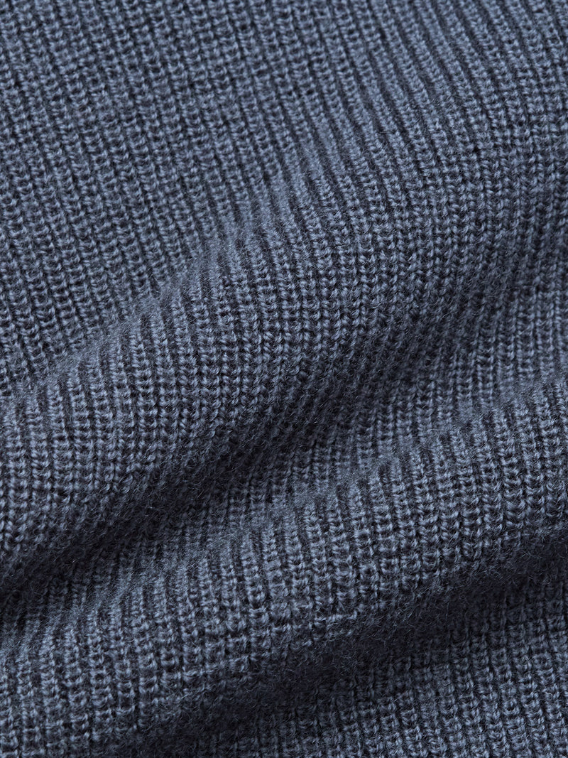 Close-up of the Porto Polo Knit - Dark Slate by Blue de Gênes, showcasing its textured ribbed fabric with vertical lines and soft folds that emphasize the luxury knitwear quality.