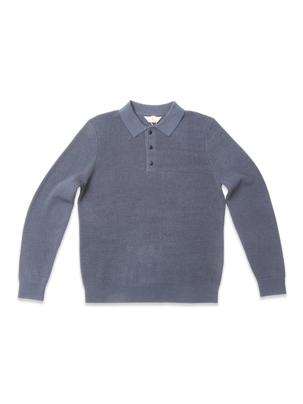 The Blue de Gênes Porto Polo Knit - Dark Slate is a long-sleeve sweater with a collar and three buttons, laid flat on a white background—luxury knitwear at its finest.