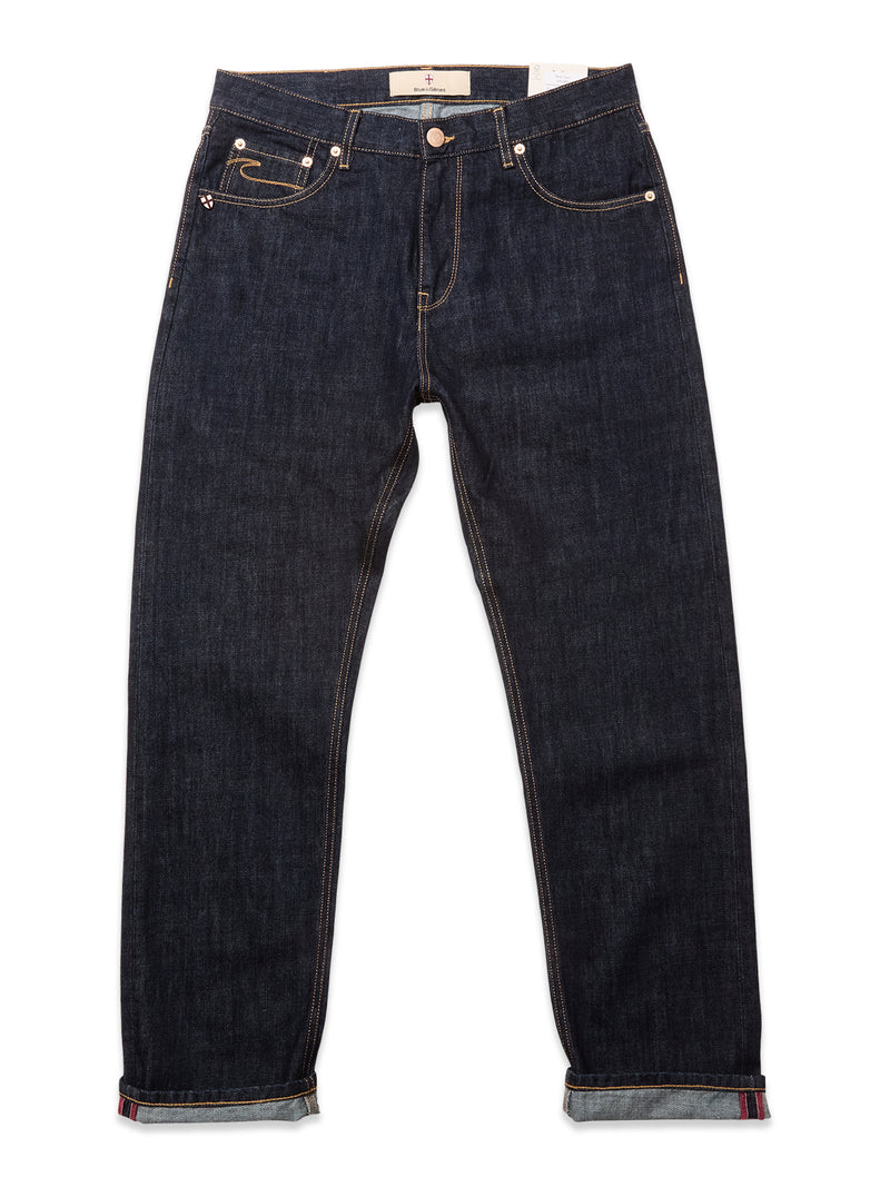 A pair of Blue de Gênes Marco Rinse Jeans in rinse wash, featuring 100% cotton dark blue denim, rolled cuffs, gold stitching, and front and back pockets, displayed flat against a white background.