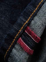 Close-up of the cuff on Blue de Gênes Marco Rinse Jeans – Rinse Wash, highlighting yellow stitching and red and white selvedge edges inside the relaxed fit dark blue denim.