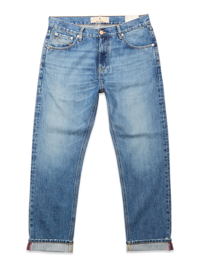 A pair of Blue de Gênes Marco Used Jeans - Used in blue, featuring a relaxed fit, classic five-pocket design, rolled cuffs, and 100% cotton denim, laid flat on a white background.