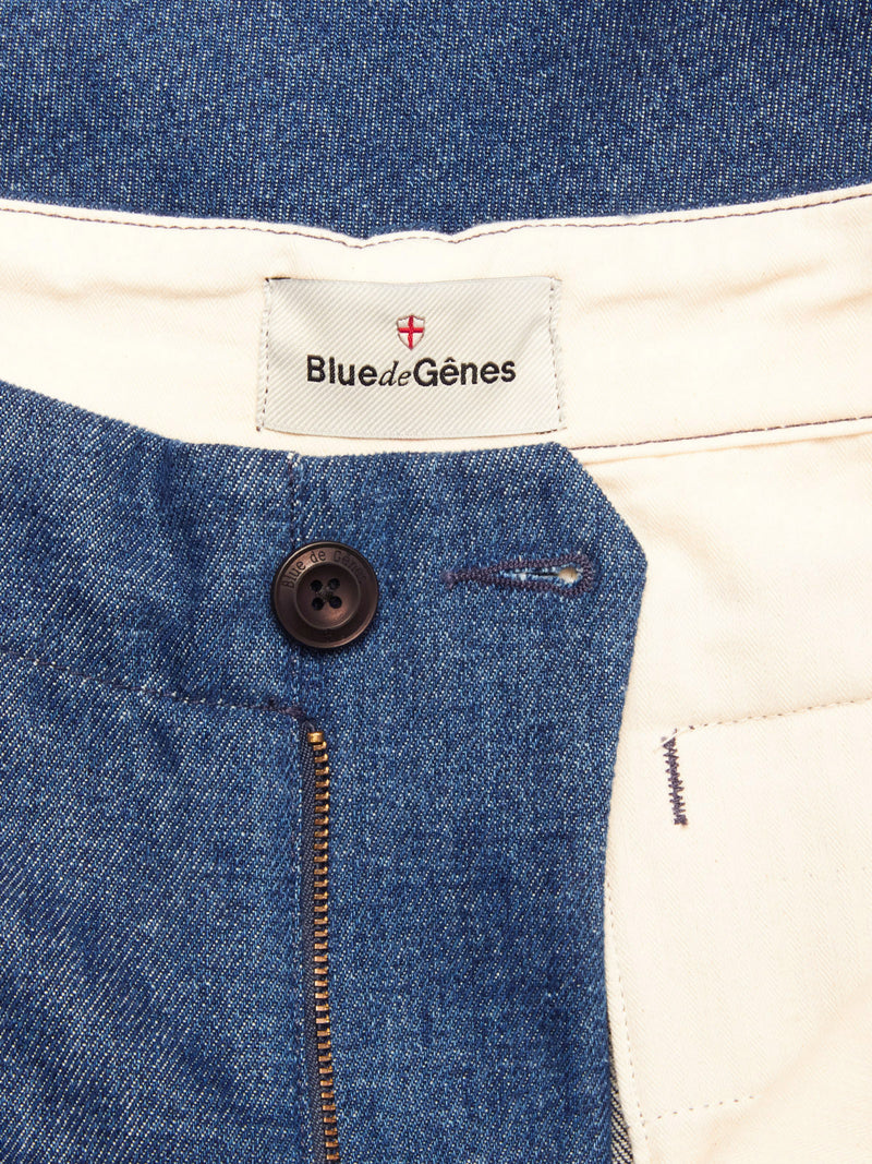 Close-up of the waistband and zipper area of the Shogun Fano Pant - Denim Blue by Blue de Gênes, featuring a black button, gold zipper, and a Blue de Gênes label on white lining, crafted from heavy cotton blend denim.