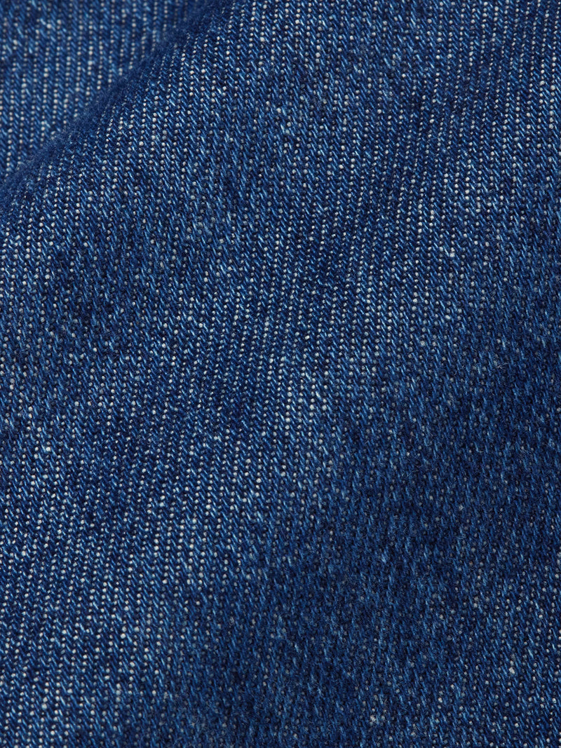 Close-up of the Shogun Fano Pant - Denim Blue by Blue de Gênes, highlighting its heavy cotton blend denim fabric with a diagonal weave and rich variations in blue tones.