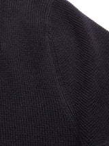 Close-up of the Otia L/S Polo Knit in Navy by Blue de Gênes, highlighting the detailed ribbed texture and stitching on the sleeve or seam.