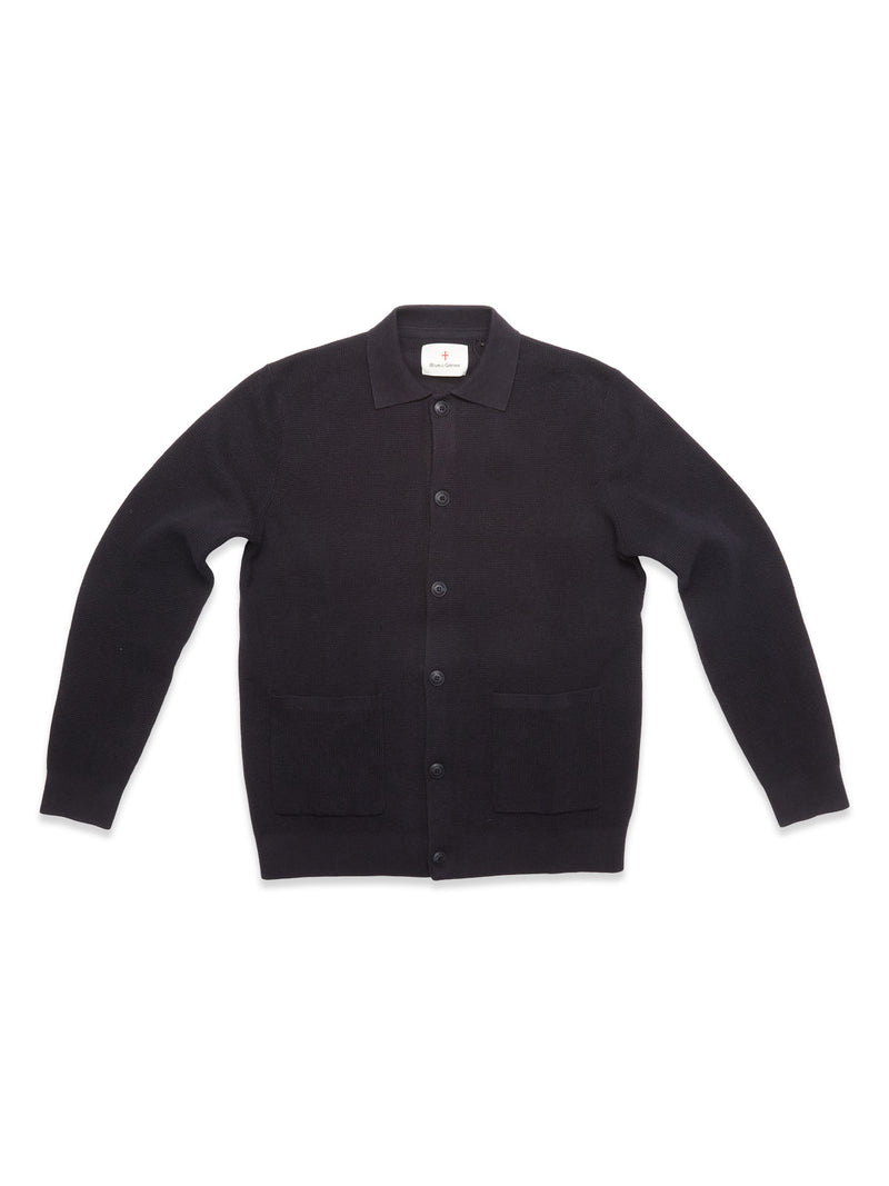 The Blue de Gênes Gifu Knit Cardigan in navy is crafted from a wool blend with long sleeves, a collar, and two front pockets. This men's knitwear is shown laid flat on a white background.