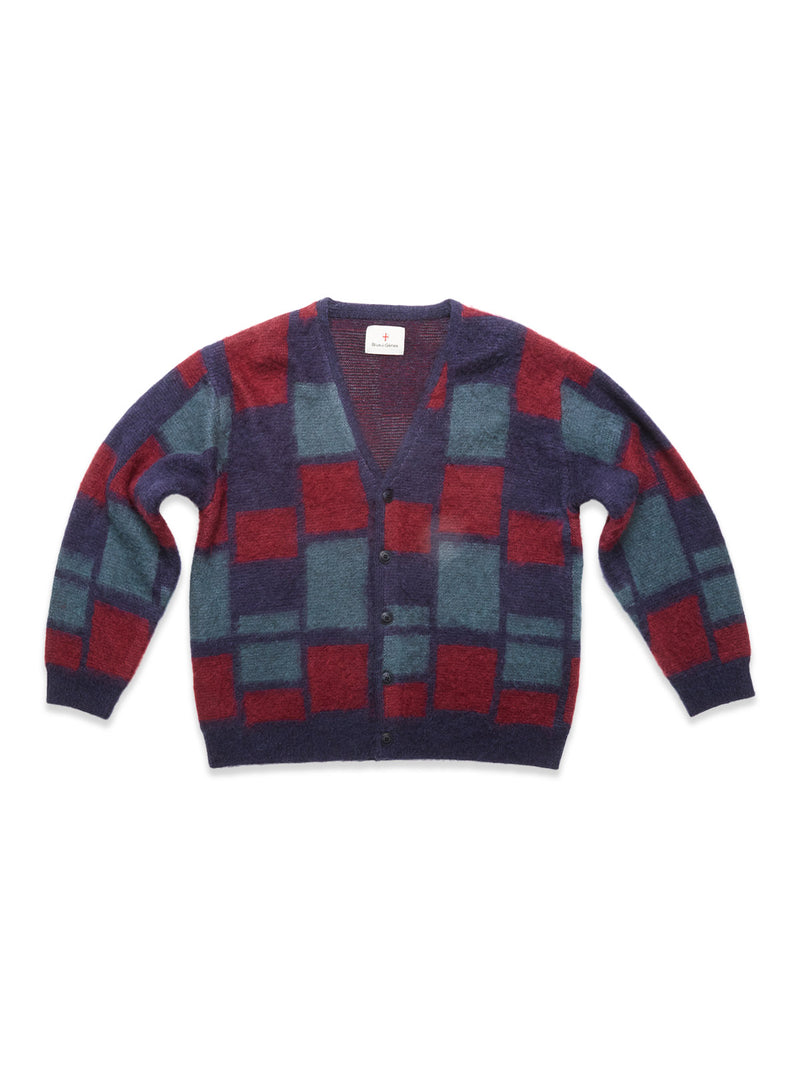 The Blue de Gênes Block Knit Cardigan - Navy Pattern is a fuzzy wool-blend, V-neck cardigan with bold red, teal, and navy checkerboard squares, long sleeves, relaxed fit, and a classic button-up style.