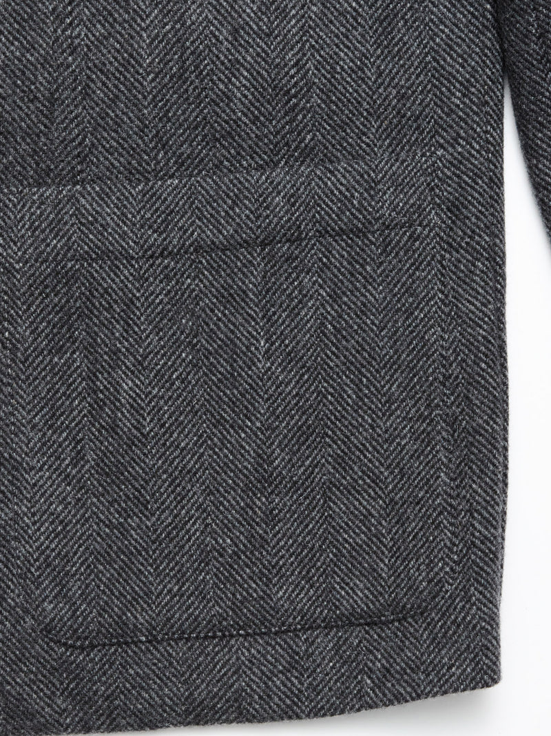 Close-up of the Fukui Blazer - Black Pattern by Blue de Gênes, showing a large rectangular front pocket and edge stitching—a refined take on relaxed tailoring.