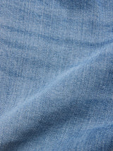 Close-up of BGvinci Hera Used Jeans by Blue de Gênes in light blue stretch denim, showcasing the fine weave texture and a subtle diagonal crease.